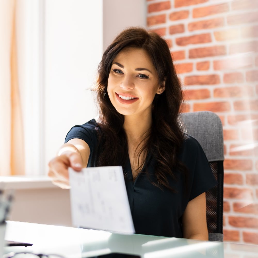 Woman handing over a paycheck