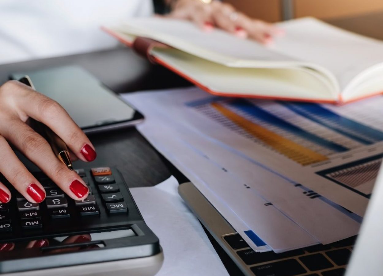 Close up of personal with a calculator and book